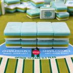 Illustrated coastal American mahjong tiles laid out on table