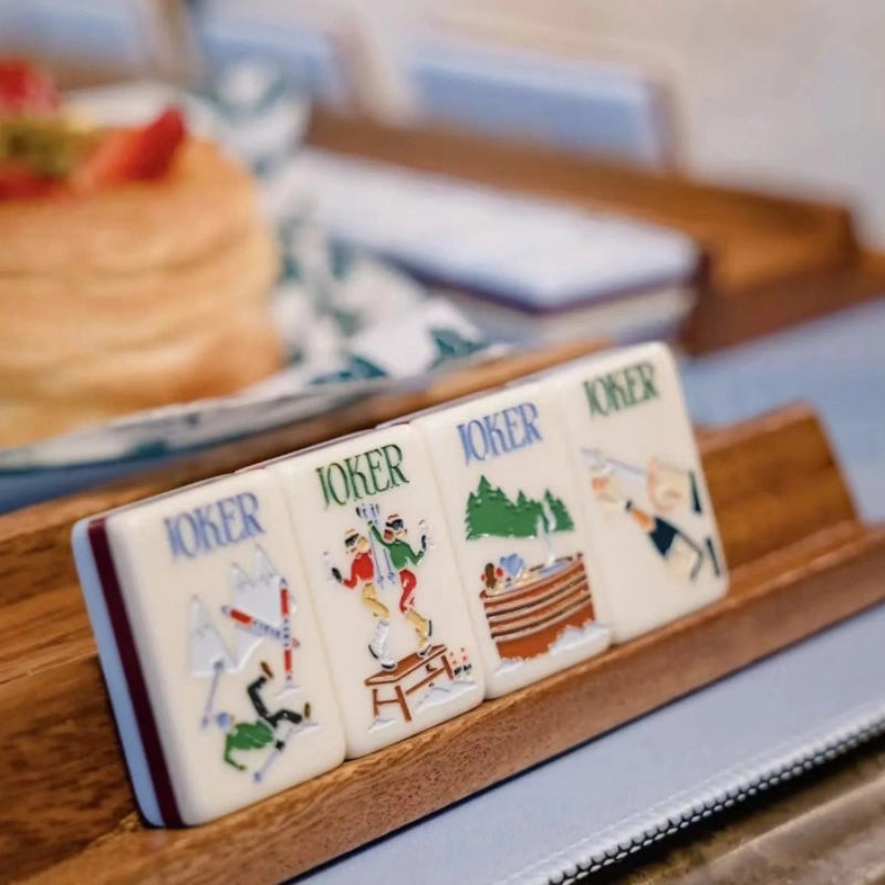 Hand holds illustrated mahjong tile
